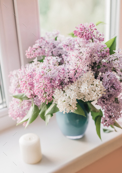 Bouquet of graceful lilacs on the window