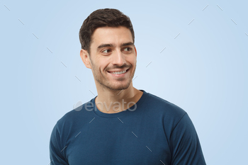 Gorgeous caucasian smiling gorgeous man in blue t-shirt having a ogle moral