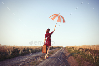 girl with suitcase and umbrella