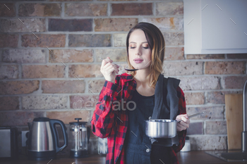 Portrait of young lady in purple shirt at kitchen