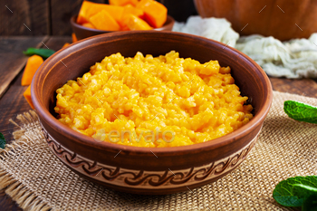 Delicious home made pumpkin porridge on wooden background. Healthy vegan food