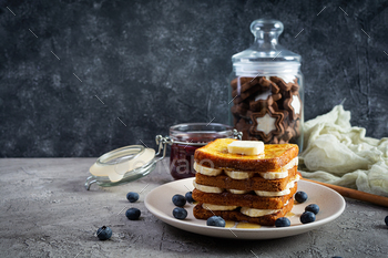 French toast with banana, blueberry, honey and strawberry jam