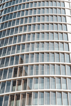 Background of a pattern of windows of a monetary building with sunset reflection