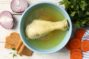 Rooster soup on white wooden background, pack up