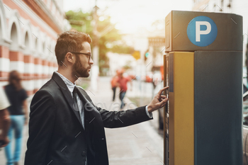 Businessman the use of Parking Meter exterior