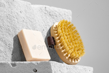 Skincare therapeutic massage brush on gray concrete block