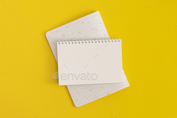 Notebook on yellow background. High see. Flat lay. Wait on to faculty thought.