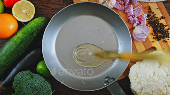 Cook pours sunflower oil into a frying pan, prime look.