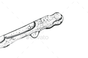 Clear pipette with cosmetics on a white isolated background