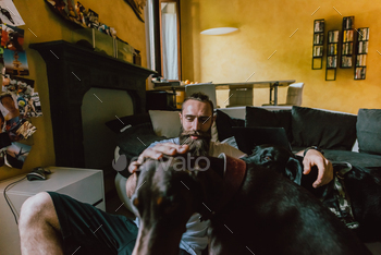 younger bearded man indoor taking part in dog