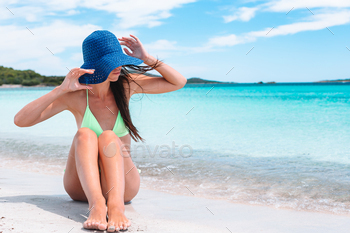 Young lady playing the solar sunbathing by very finest turquoise ocean