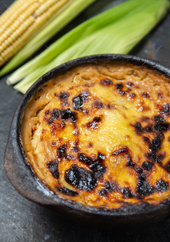 Chilean food. Broken-down Pastel de Choclo corn pie. Red meat meat with onion, rooster and egg lined