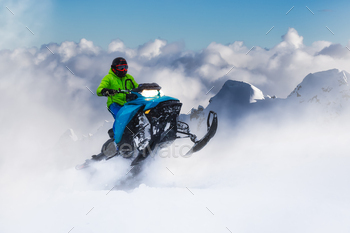 Adventurous Man Using a Snowmobile in white snow