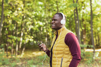 African american man listens song in spring park reproduction home and residing for promoting. Intention, app