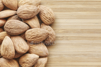 Shut up image of almonds on a wooden background