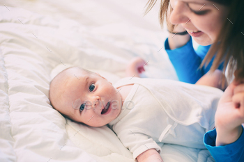 Mom and child on a white mattress