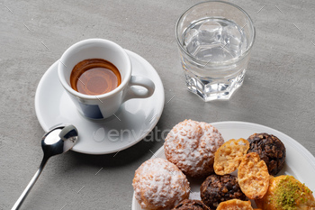 Cup of espresso and cookies on a gray desk