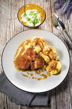 Braised pork neck in personal sauce served with boiled potatoes.