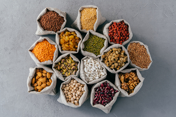 Top look of minute cloth sacks stand around, consisted of healthy dried fruit and cereals