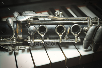 An antique clarinet leaning piano