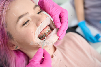 Orthodontist checks the system for the correction of the dentition