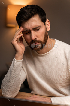 Younger tired wired overworked businessman freelancer exhausted after exhausting work