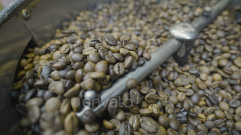 Shut-up of espresso beans stirred and roasted. Action. Particular machine mixes espresso beans for thermal