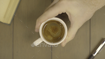 Human Hand Holding Coffee Cup Morning Drinks. Male moves a Cup of coffee. Cup of coffee with flowing