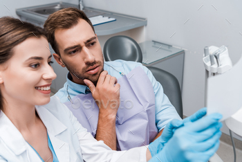 selective point of curiosity of gorgeous man come dentist smiling in hospital