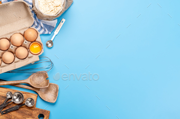 Cooking substances and utensils on blue background