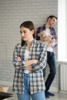 Upset disappointed girlfriend is angry at boyfriend after fight and attempting forward to apology.