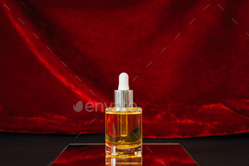 face oil on a center of attention on with red velvet and murky paper background