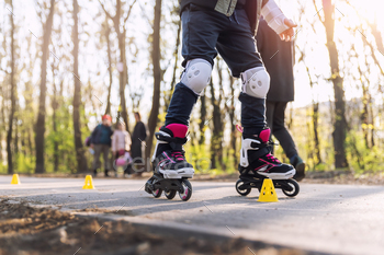 Neighborhood of babies skills having fun finding out inline curler skate slalom with plastic cones on