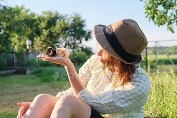 Newborn toddler chickens in hand of farmer girl