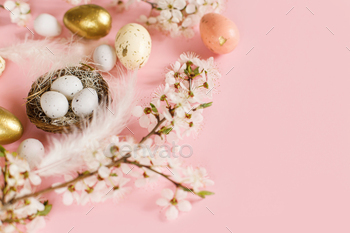 Orderly Easter eggs in nest, cherry blossoms and feathers on crimson background with copy field