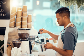 Coffee shop, barista and restore with a person at work utilizing a machine to pour a drink in the kitchen.