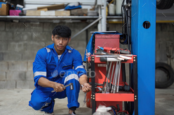 Portrait Shot of a Lovely Mechanic Engaged on a Automobile in a Car Carrier. Official Repairman