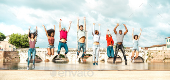 Diverse multi racial pals leaping at Rimini city