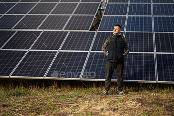 Man on the background of solar panels.  Eco vitality.