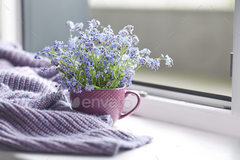 Violet warm plaid blanket on wooden rustic bench. Photo toned, selective focal point.