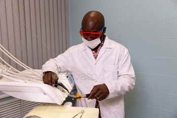 graceful doctor with dental equipment in his fingers in a dental sanatorium