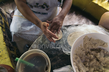 Female hand making inclined Tortillas