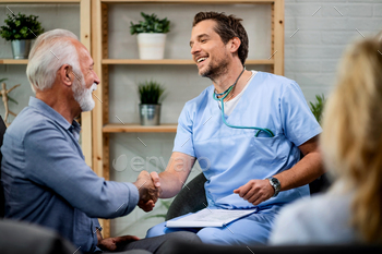 Ecstatic doctor and old man handshaking while greeting steady by a home command to.