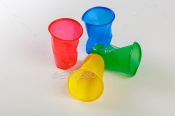 Multicolor disposable plastic glasses isolated on white background