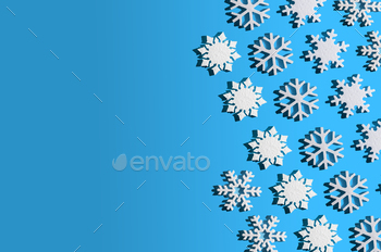 Christmas background. Snowflake pattern. White snowflakes on blue. Snow. Iciness mood. Conceptual