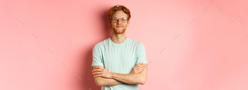 Portrait of gratified caucasian man with pink hair and beard, tainted palms on chest and smiling with