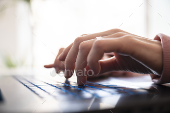 Low attitude closeup look of female fingers typing on computer