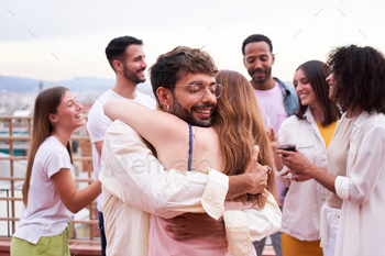 Two friends hugging initiate air throughout a party.