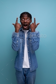 shut-up portrait of an brisk explosive young in type american man with dreadlocks in a denim