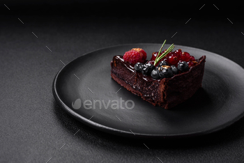 Delectable sweet chocolate brownie cake with blueberries, currants and raspberries